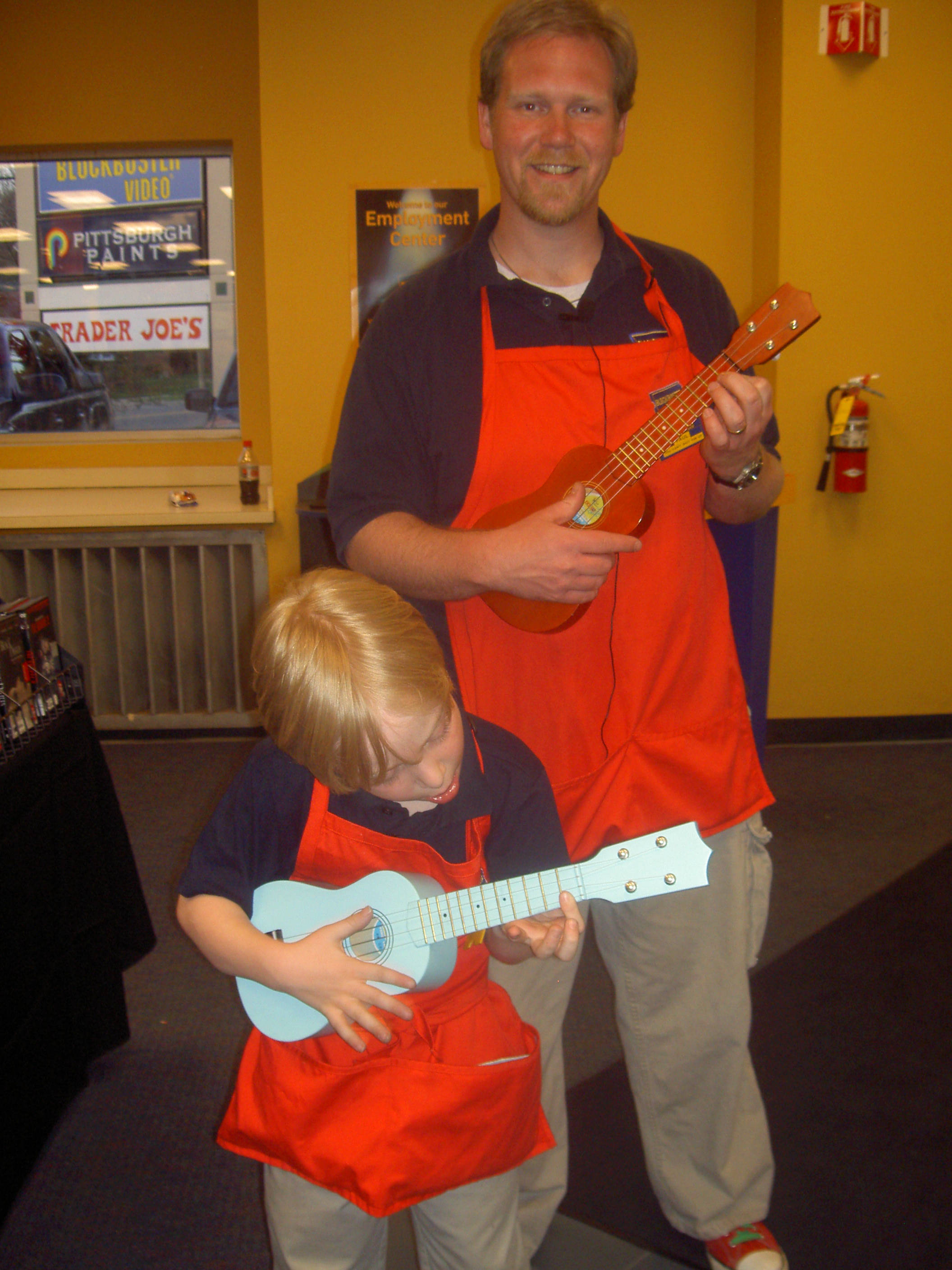 a father and son playing ukulele